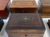 five wooden boxes sitting on a table with a clock on top of them