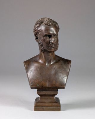 a bronze bust of a man on a pedestal