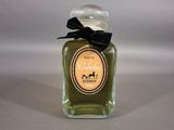 a bottle of perfume with a black bow on it