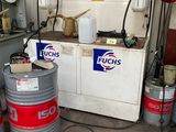 a bunch of barrels that are sitting in a garage