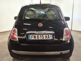 a small black car with a license plate on the back of it