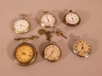 many different types of pocket watches on the table
