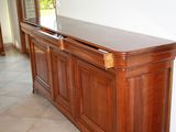 a wooden cabinet with a mirror on top of it