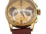 an image of a gold wrist watch with a brown leather strap