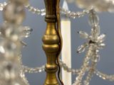 a close up of a gold colored chandelier with glass beads hanging from it
