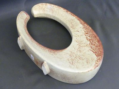a white toilet with a brown lid on a black background