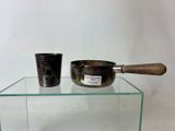 two bowls and a spoon sitting on a glass table