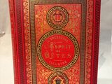 a red book with gold trimming and a red cover