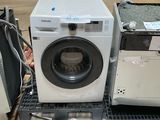 a washer and dryer sitting on the floor in a room
