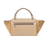 a beige leather handbag with a zipper on the front