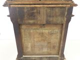 an old wooden cabinet with a bird on top of it