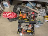 a pile of tools sitting on the floor in a garage