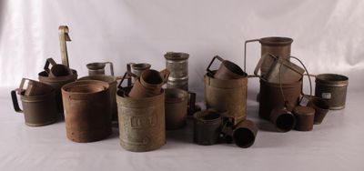 a lot of old metal containers sitting on a table