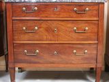 a wooden dresser with marble top in a room