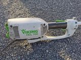 a close up of a chainsaw laying on the ground
