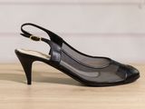 a pair of black high heel shoes on a wooden table