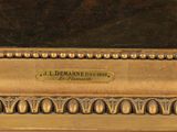an oil painting of a golden frame with a plaque on it
