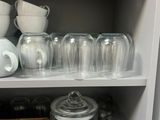 a lot of dishes and cups on the shelves