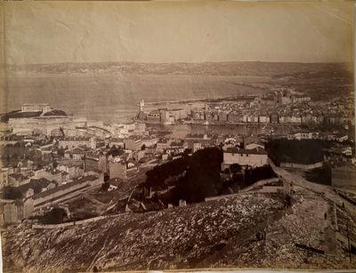 an old photo of a view of a town from the top of a hill