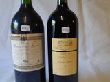 two bottles of wine sitting next to each other on a table