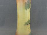 a vase that is sitting on a table with a gray background