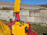 a yellow and red machine that is sitting in the grass