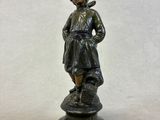 bronze figurine of a boy with a bird on his shoulder