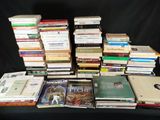 a lot of books that are stacked on top of each other