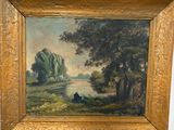 une peinture à l'huile posée sur un chevalet, représentant une rivière et des arbres