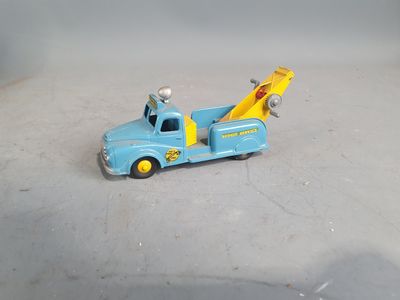 a toy truck with a crane on the back of it