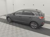 a grey car parked in a garage with a checkered floor