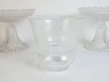 three glass vases sitting next to each other on a table