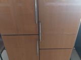 a refrigerator that is sitting on a pallet in a room