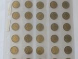 some gold coins are in a clear plastic bag on a white surface