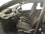 the interior of a small car with black leather seats and a steering wheel