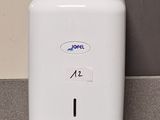 un distributeur de papier toilette fixé au mur dans une salle de bains