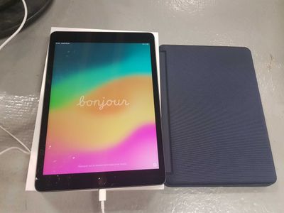 an image of a tablet sitting on top of a table next to a charger