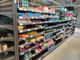 a lot of shelves in the store with food on them