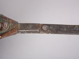 a close up of a metal object with a face on it