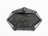a metal belt buckle with a picture of a man on a motorcycle