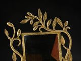 a mirror that is sitting on a table with a black background