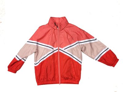 red and beige windbreaker jacket with black and white stripes