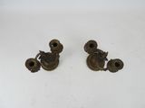 pair of antique brass candlesticks on a white background