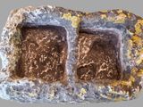 an image of a rock with two small holes in it