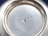 a close up of a silver plate with a clock on it