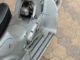 a motor scooter that is parked on the side of the road