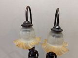 pair of antique glass lamps with a bronze base and a frosted glass shade