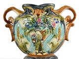 a vase with a floral design on it sitting on a stand