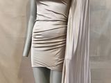 the mannequin is wearing a white dress with a cape over it