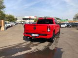 a red truck that is parked in a parking lot